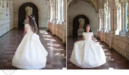 Young girl in white dress in a hallway.