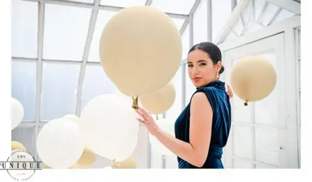 Woman in blue dress with balloons.