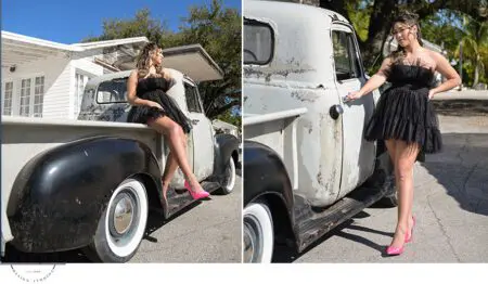 Woman in black dress by vintage truck.