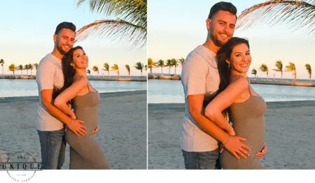 Pregnant couple on a beach at sunset.
