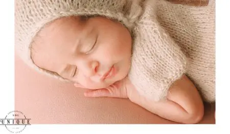 Sleeping newborn baby wearing a knitted hat.
