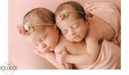 Twin baby girls sleeping with flower headbands.