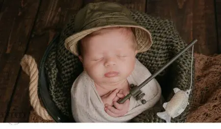 Sleeping baby wearing a hat and fishing.