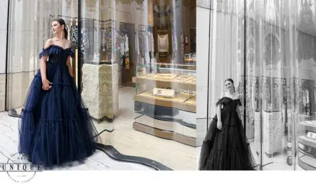 Woman in a blue gown standing outside a store.