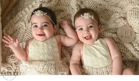 Twin baby girls smiling at seven months.