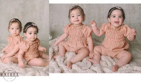 Twin baby girls in matching outfits.