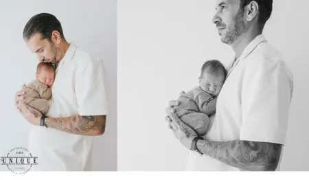 Father holding newborn baby in his arms.
