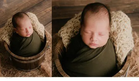 Newborn baby asleep in a wooden bucket.