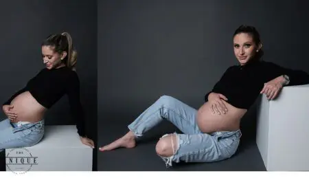 Pregnant woman in jeans and black top.
