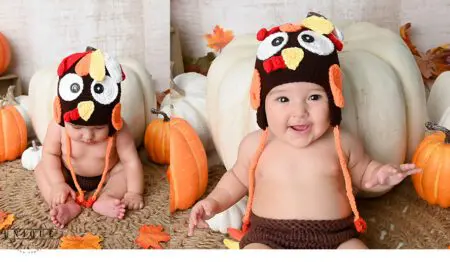 Baby in a turkey costume with pumpkins.