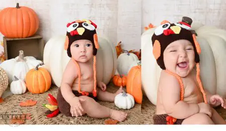 Baby in turkey costume with pumpkins.