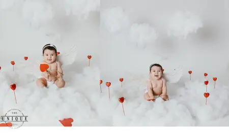 Baby angel with wings holding arrow on clouds.
