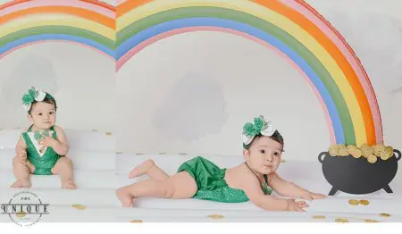 Baby girl under rainbow with pot of gold.
