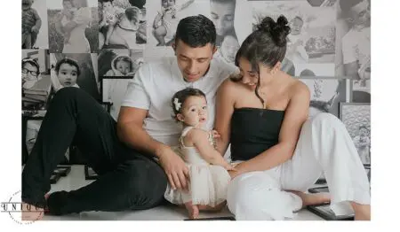 Family portrait with baby girl and photos.